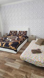 a bedroom with two beds and a bedspread with a monkey on it at La Terrazza di Rovaglioso in Palmi
