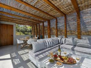 a living room with a couch and a table with food at Villa Irene Tolo in Tolo