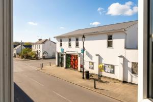 a street with a store on the side of a building at Motcombe Cottage in Hatherleigh