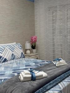 a bedroom with a bed with towels on it at Beach house airport in Fiumicino