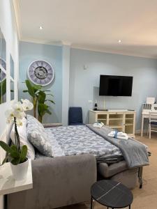 a bedroom with a bed and a clock on the wall at Beach house airport in Fiumicino