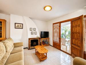 a living room with a couch and a fireplace at Stay in Costa Hispania in Santa Pola