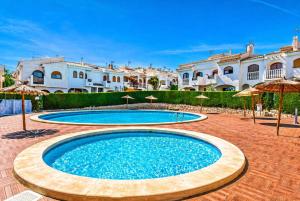 a pool in the middle of a courtyard with umbrellas at Stay in Costa Hispania in Santa Pola