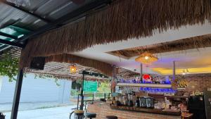 a bar with a counter and a bar with a bartender at Oasis2 Phuket Airport Glamping in Phuket