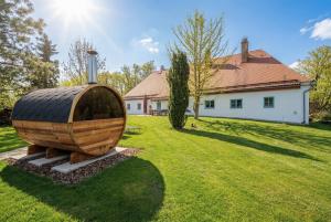 a large wooden object in a yard with a house at Bezdrevská Bašta in České Budějovice