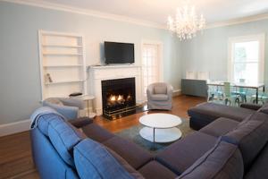 a living room with a couch and a fire place at Swamp Rabbit Inn TR in Travelers Rest