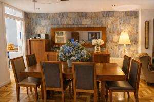 a dining room with a wooden table and chairs at La Bahía in Baiona