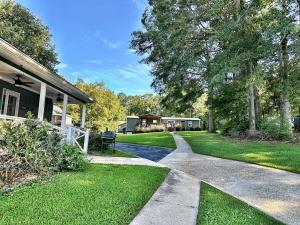 a house with a walkway leading to a yard at Charming Lake Front Home and Pavilion in Milledgeville