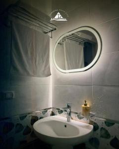 a bathroom with a sink and a mirror at Pyramids Green View in Cairo