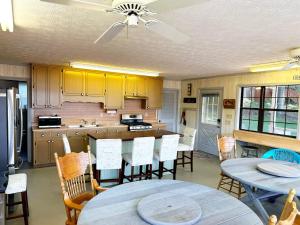 a kitchen with a table and chairs and a ceiling fan at Charming Lake Front Home and Pavilion in Milledgeville
