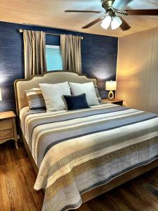 a bedroom with a large bed with a ceiling fan at Charming Lake Front Home and Pavilion in Milledgeville