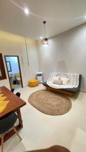 a room with a bed and a table at CASA TEMPORADA BARREIRINHAS Yellow 3 in Barreirinhas