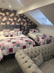 a attic bedroom with two beds and a couch at Fox lodge in Blackpool