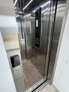 a elevator in a building with a metal door at Cayo Exclusive Hotel in Vlorë