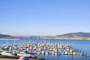 a bunch of boats are docked in the water at La Bahía in Baiona