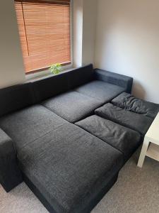 a large couch in a room with a window at 40 kvm lejlighed in Kjellerup