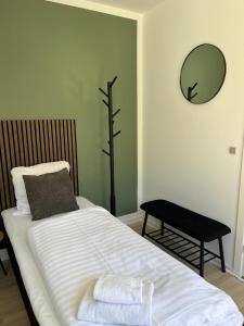 a bedroom with a bed and a mirror on the wall at Hotel Færgelunden in Jægerspris