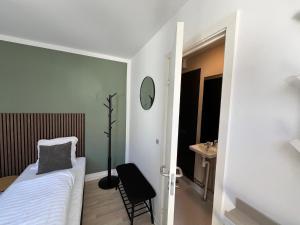 a bedroom with a bed and a table and a chair at Hotel Færgelunden in Jægerspris