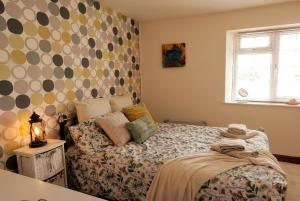 a small bedroom with a bed and a window at Motcombe Cottage in Hatherleigh