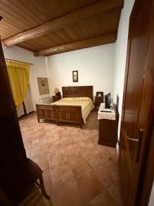 a bedroom with a bed and a television in it at Cascina Filipot in Cerretto Langhe
