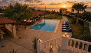 an aerial view of a house with a swimming pool at Bella Villa with Private Pool & Sea View Ideal for Groups in Vaia