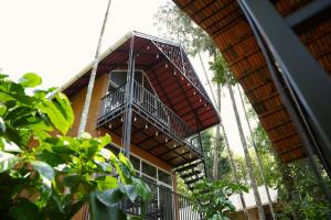 a building with a balcony on the side of it at Wanderlust Villas in Pinangode
