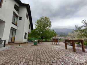 a group of benches sitting outside of a building at Hideout apartments Travnik in Travnik