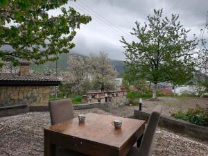 a wooden table and chairs on a patio at Hideout apartments Travnik in Travnik +2 photos