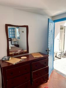 a dresser with a mirror on top of it at Nizar Surf Morocco in Taghazout +94 photos