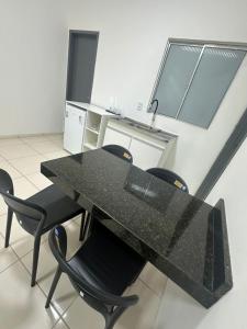 a black table and chairs in a room at Apto Centro Arapiraca in Arapiraca