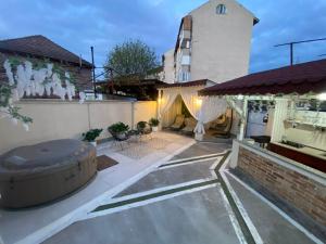 a backyard with a pool and a building at Casa Denis la 50m de Castel! in Hunedoara