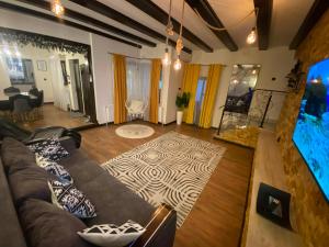 a living room with a couch and a rug at Casa Denis la 50m de Castel! in Hunedoara