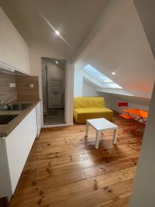 a kitchen and a living room with a table at Olivia in Argenteuil