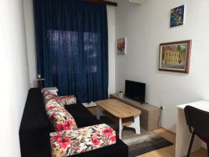 a living room with a couch and a table at Hideout apartments Travnik in Travnik