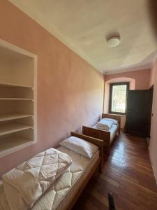 a room with two beds and a window at Marghita La Salle in La Salle