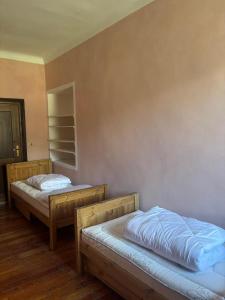 two beds in a room with a wall at Marghita La Salle in La Salle
