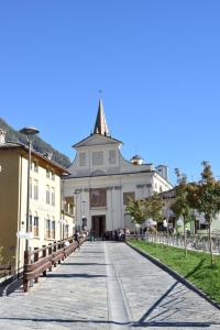 a large white building with a tower on a street at Marghita La Salle in La Salle