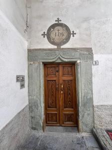 a large wooden door with a clock above it at Marghita La Salle in La Salle
