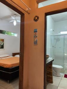 a bedroom with a bed and a bathroom at Floripa Beach House Hostel in Florianópolis +92 photos