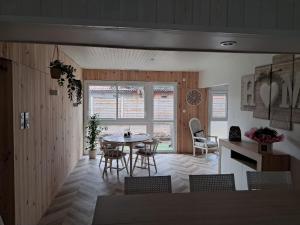a kitchen and dining room with a table and chairs at Maison de jacque in Mimizan +8 photos