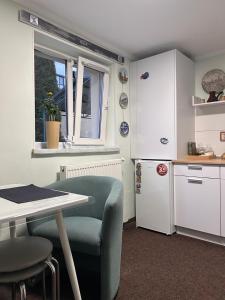 a kitchen with a table and a table and a refrigerator at Книжка in Vinnytsya
