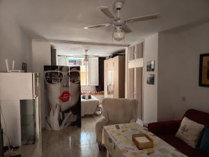 a living room with a couch and a table with a painting of a woman at Casa Angeles in Castell de Ferro +33 photos