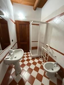 a bathroom with two sinks and a shower at Cascina Filipot in Cerretto Langhe +45 photos