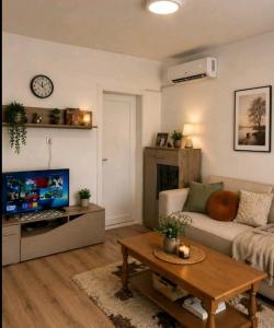 a living room with a couch and a table at Stan na dan ,, Vidovdan ,, in Nevesinje