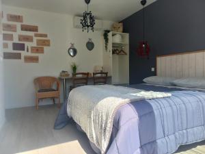 a bedroom with a bed and a table and chairs at C La Belle Vie in Pessac
