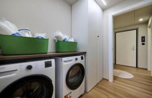 a laundry room with a washer and dryer at Monolocale 1 - via Sassi, Lecco in Lecco +8 photos