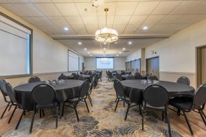 a conference room with tables and chairs and a projection screen at Prestige Golden Hotel in Golden +60 photos