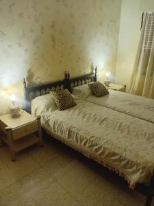 a bedroom with two beds and a table at Amelia in San Juan