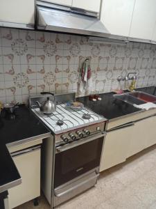 a kitchen with a stove and a sink at Amelia in San Juan +3 photos