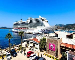 a cruise ship docked at a marina with a large cruise ship at Villa Port Bodrum in Bodrum City